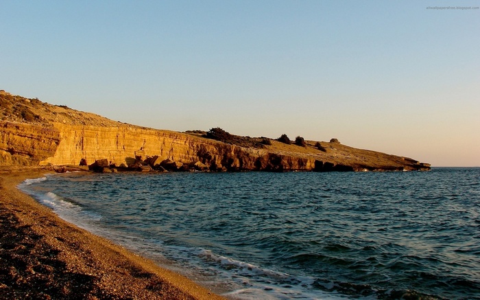 Coastal cliffs and beach at sunset