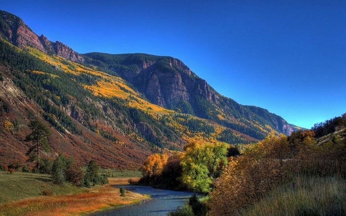 Mountain valley with river and autumn trees