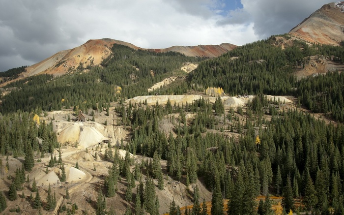 Mountain landscape with abandoned mine and evergreen forest