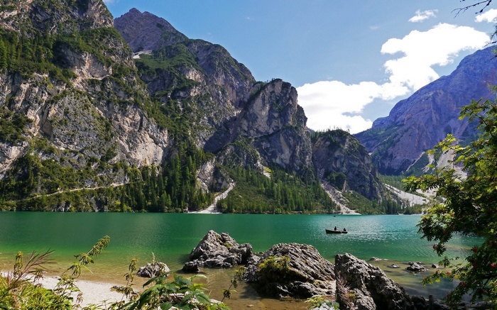 Boat on a mountain lake with rocky shore