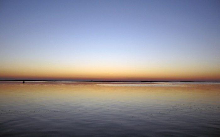 Sunset over a calm body of water