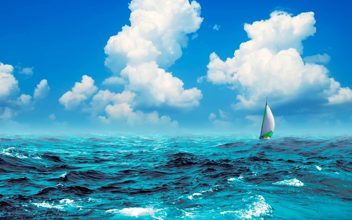 Sailboat on a wavy ocean under a cloudy blue sky