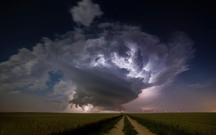 Lightning storm over a field at night