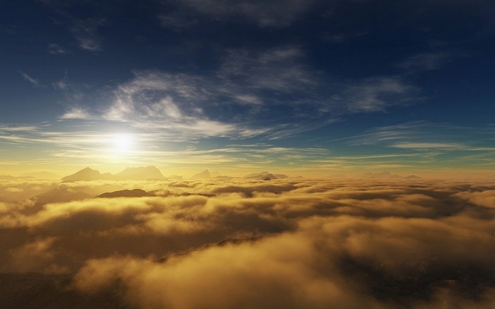 Mountains above clouds at sunset