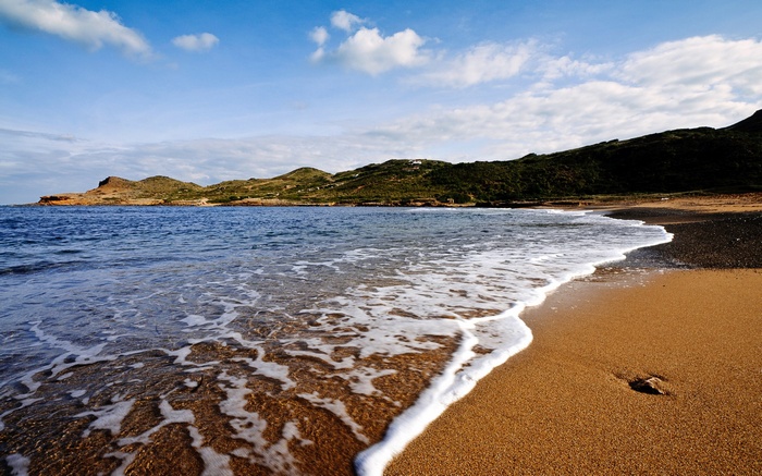 Beach with waves and hills