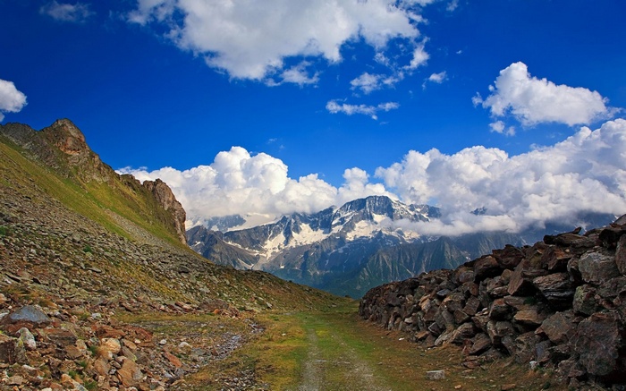 Mountain landscape with rocky slopes and snow-capped peaks