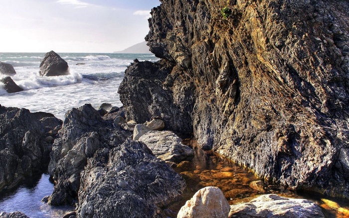 Rocky coastline with waves crashing against rocks