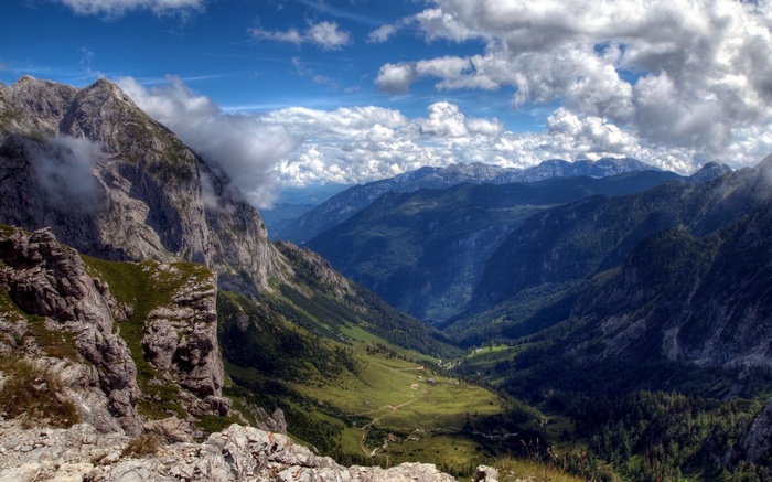 Mountain valley with clouds and blue sky