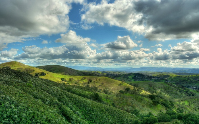 Rolling green hills under a cloudy sky
