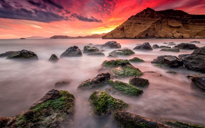 Rocky coastline at sunset with dramatic sky