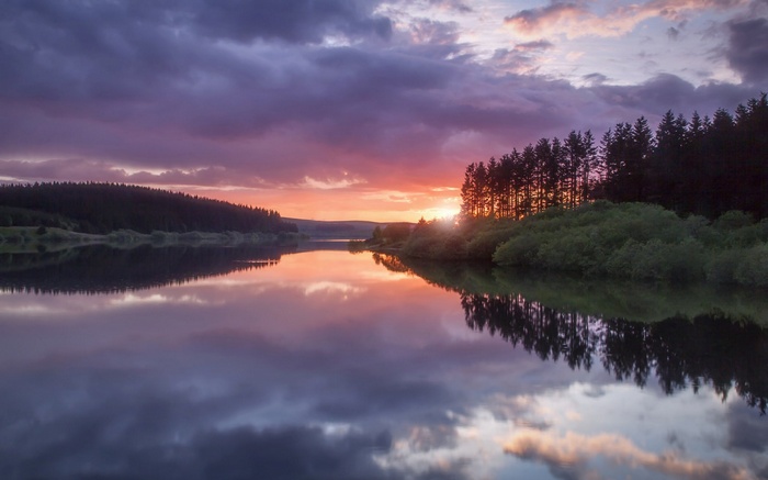 Sunset over a lake with reflections and trees