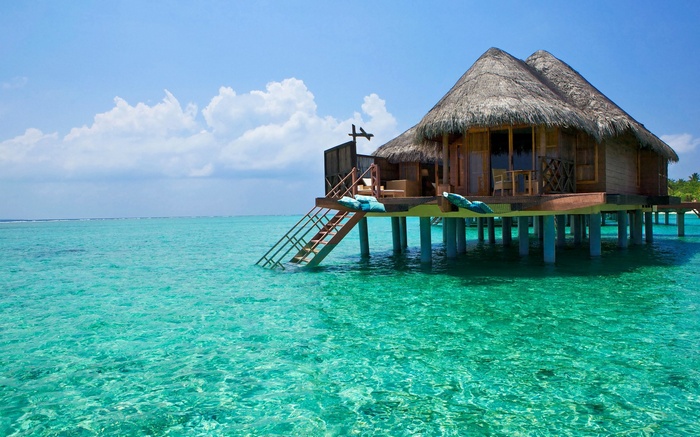 Overwater bungalow in turquoise ocean