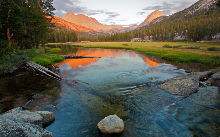 Mountain valley with river at sunset