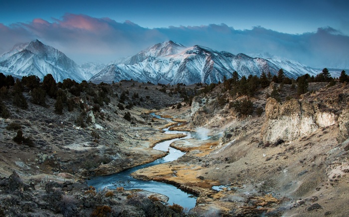 Snow-capped mountains and a winding river valley