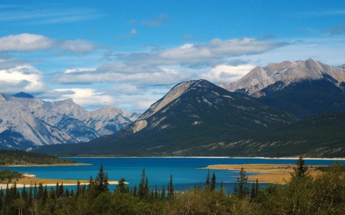 Turquoise lake and mountains under a cloudy sky
