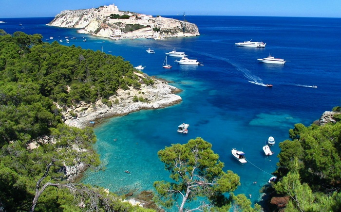 Boats in a bay near a fortified island