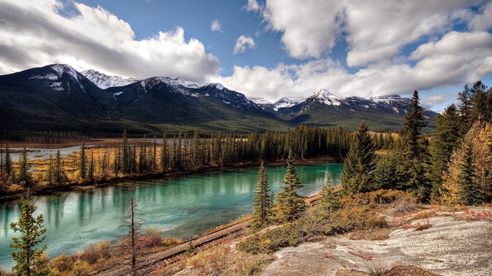 Turquoise river and snow-capped mountains in autumn