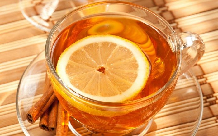 Cup of tea with lemon and cinnamon sticks