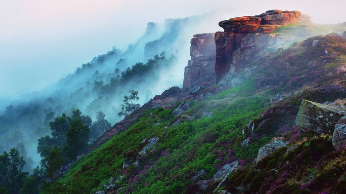 Misty mountains with rocky outcrops and heather