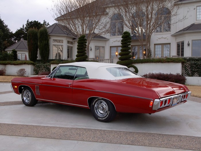 Red Chevrolet Impala Convertible in Front of Mansion