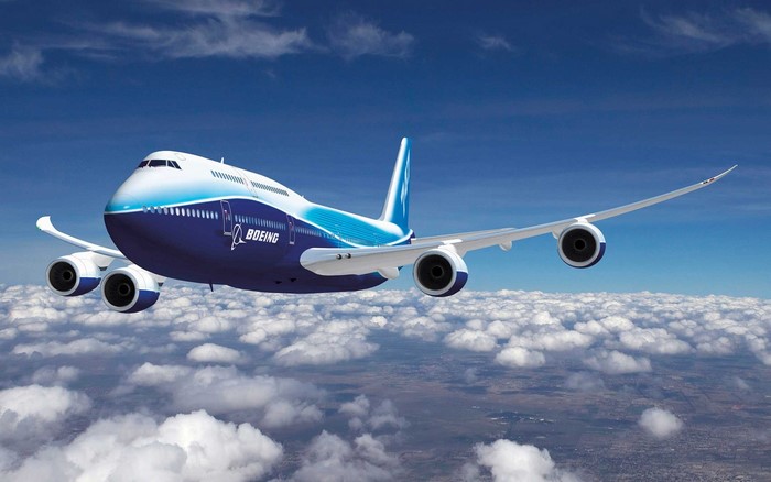Boeing 747 Airplane flying above clouds