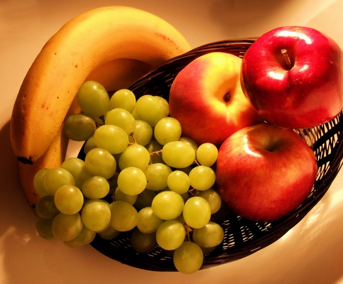 Fruit basket with bananas, apples, and grapes