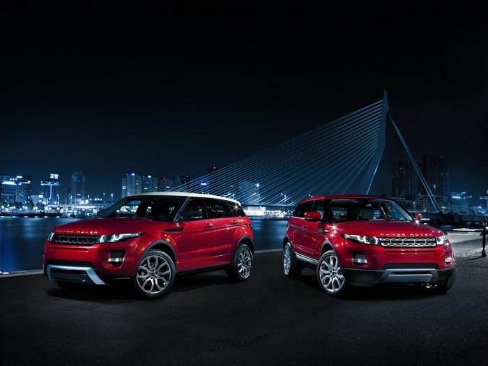 Two red Range Rover Evoque cars at night