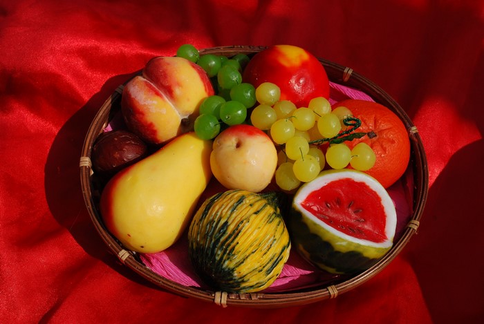 Fruit in a basket on red fabric