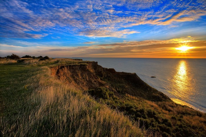 Sunset over a cliff by the sea