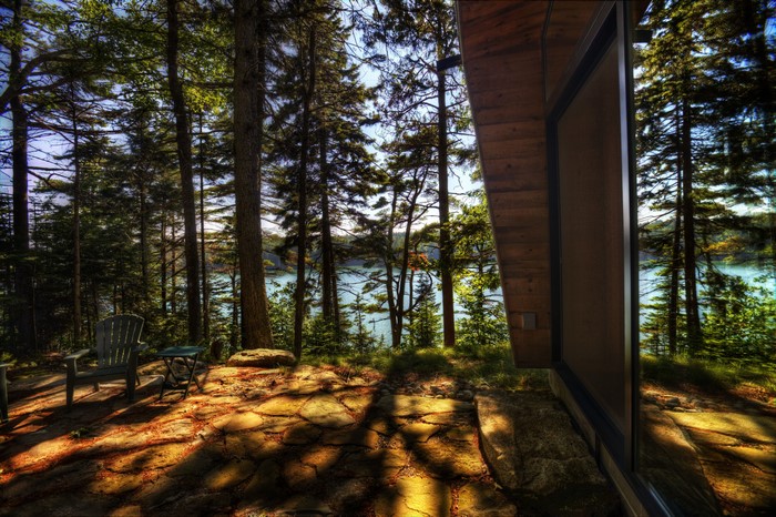 Cabin porch with lake view in forest