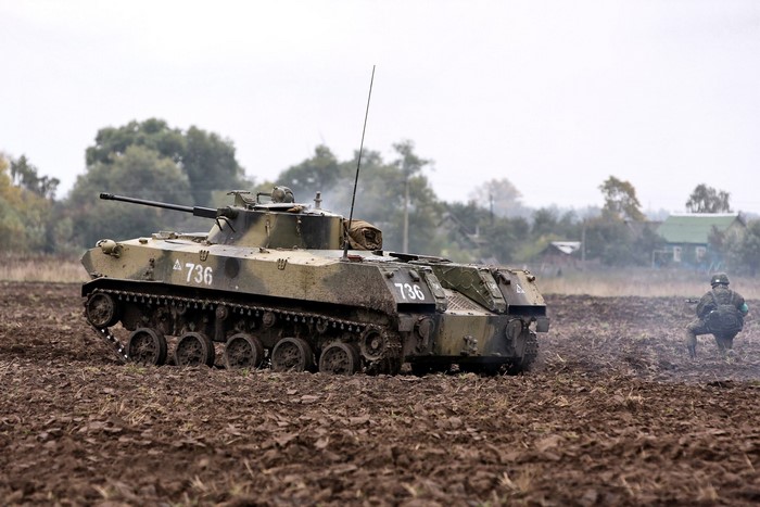 Infantry fighting vehicle with soldier in field