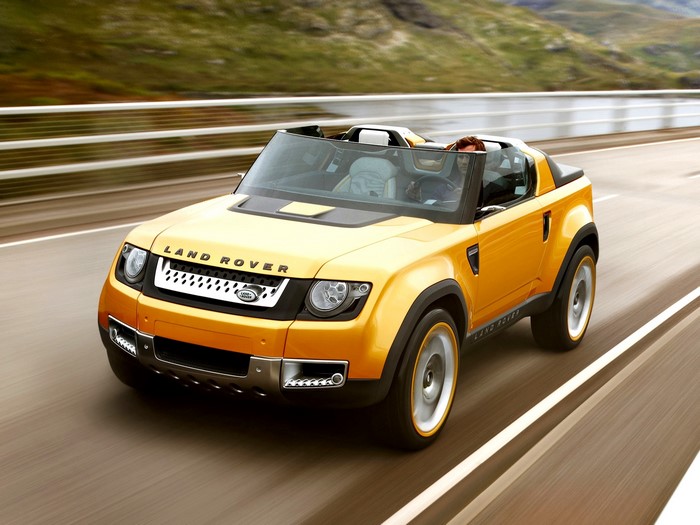 Yellow Land Rover convertible driving on a road