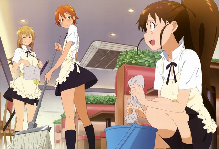 Three waitresses cleaning a restaurant