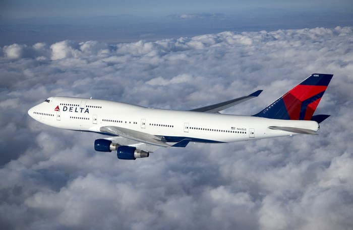 Delta Boeing 747 Airplane Flying Above Clouds