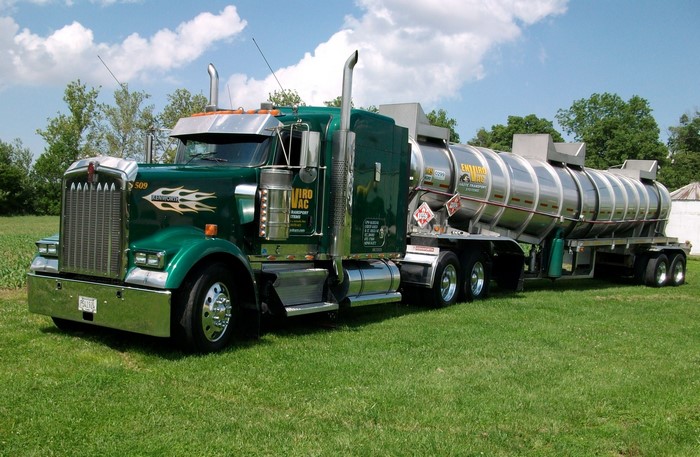 Green Kenworth tanker truck with flames