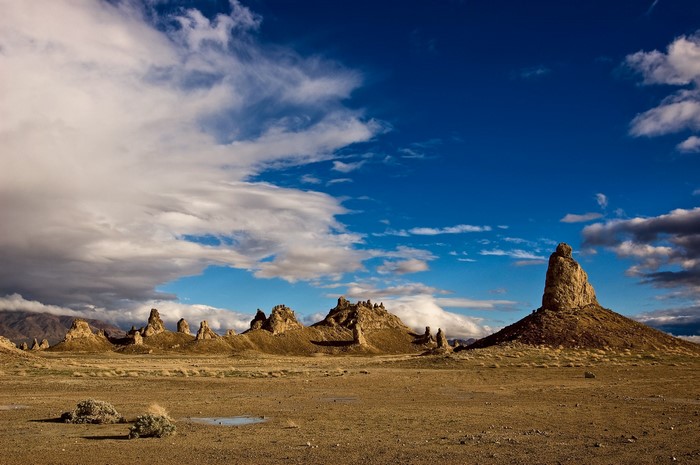 Desert landscape with rock formations and clouds