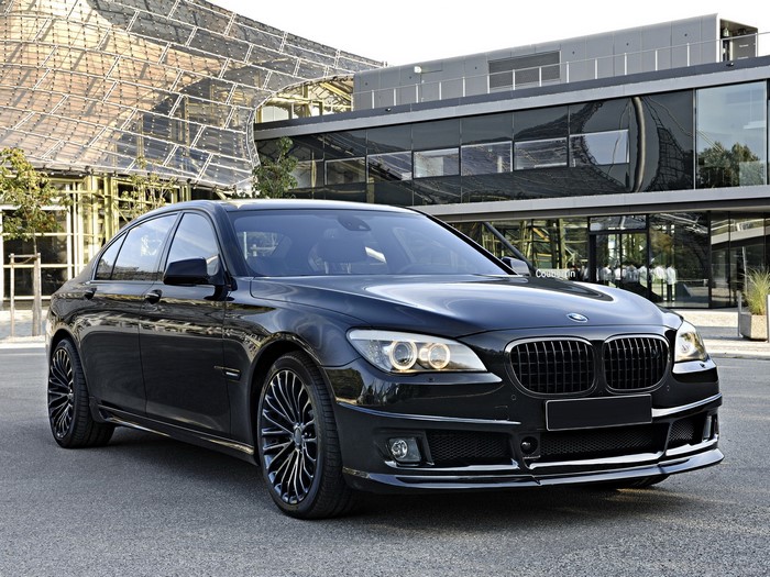 Black BMW 7 Series Sedan in front of modern architecture