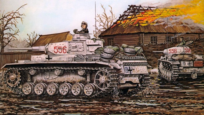 German tanks advance past burning building