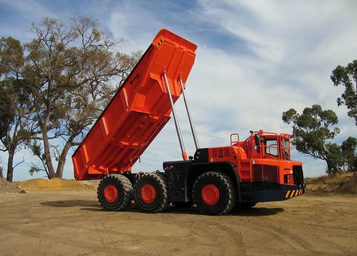 Orange dump truck with raised bed