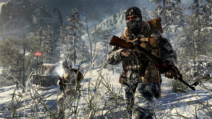 Soldiers in a snowy forest with a military outpost