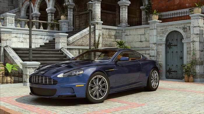 Blue Aston Martin parked in front of a stone building