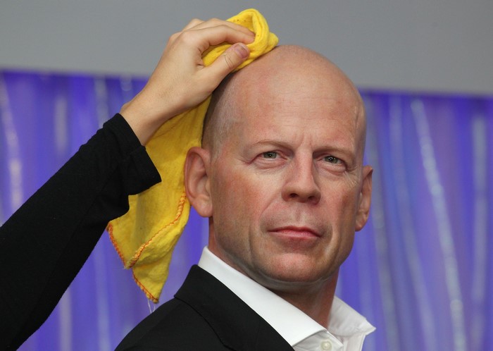 Bruce Willis being cleaned with a yellow cloth