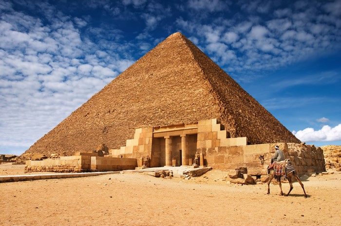 Pyramid in Egypt with a man on a camel