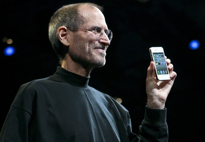 Steve Jobs holding an iPhone