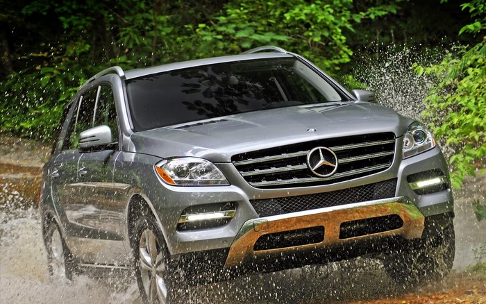 Silver Mercedes-Benz SUV driving through water