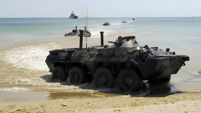 Amphibious military vehicles landing on a beach