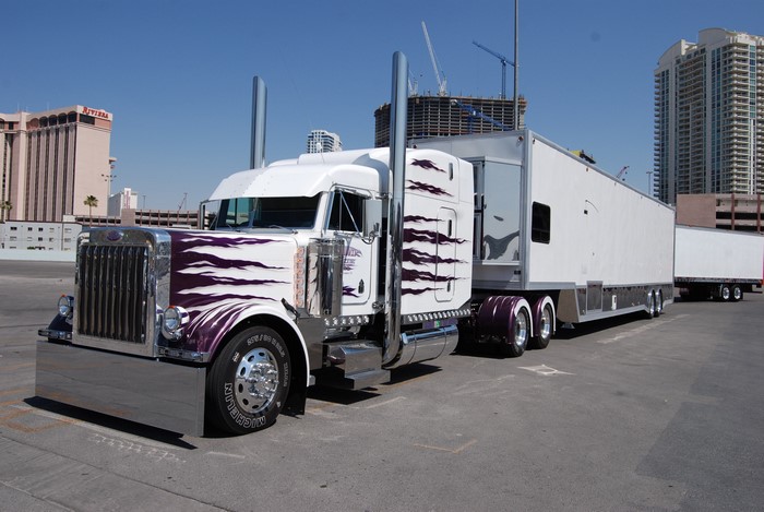Peterbilt truck with custom purple flames and trailer