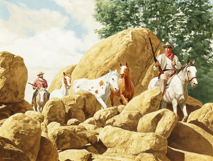 Cowboys and horses in a rocky, desert landscape