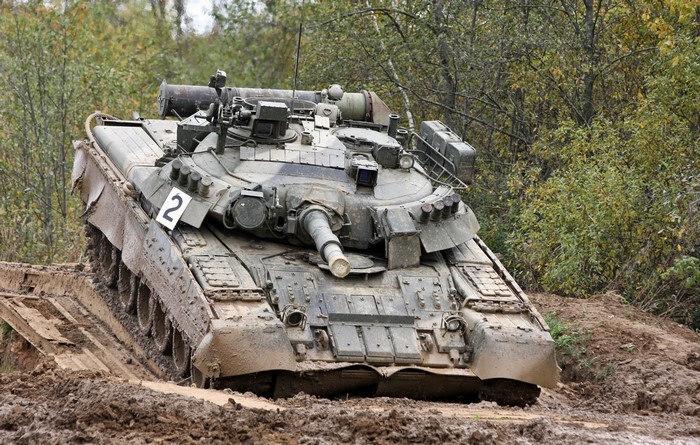 T-72 tank driving through mud