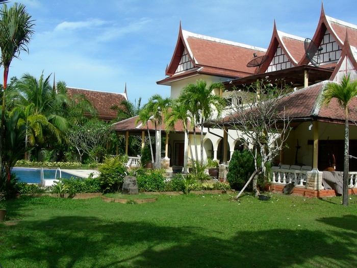 Tropical resort with swimming pool and traditional architecture